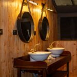 Sabora Mahogany Double-Sink Vanity with Round Wall-Hung Mirrors.