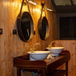 Sabora Mahogany Double-Sink Vanity with Round Wall-Hung Mirrors.